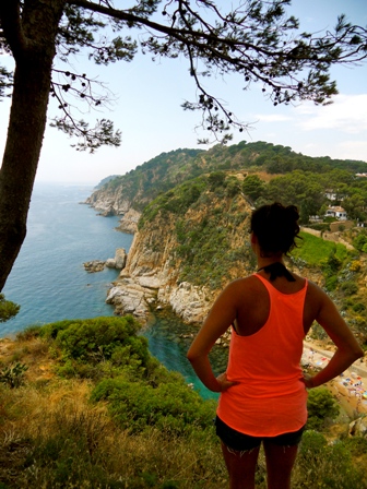 Krista overlooking cliff and ocean in Spain