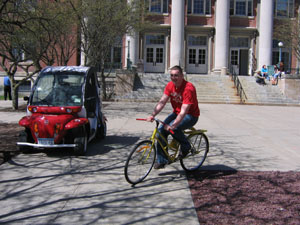 student on yellow bike by Gem Car