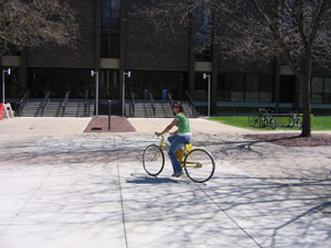 student riding yellow bike